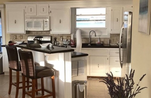 Ludington House | Upper level rental with large family room and huge wrap around deck full kitchen