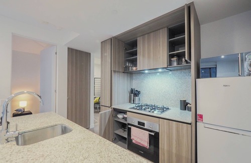 Carlton South Apartment | Walk through the art-filled lobby, and you'll find a full range of resident amenities, with pools and gym, neighbour to the world-renowned Royal Melbourne Institute of Technology (RMIT).