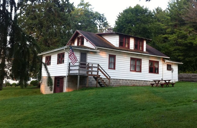 1920s Cuba Lake Cottage with 3 bedrooms and one bathroom, large yard, and dock.