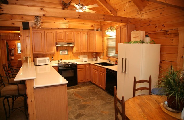 2 story log cabin on 50 acres. Large fireplace, hot tub, covered porch.