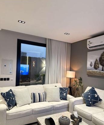 A cozy two-bedroom apartment with a living room and a patio that inspires relaxation