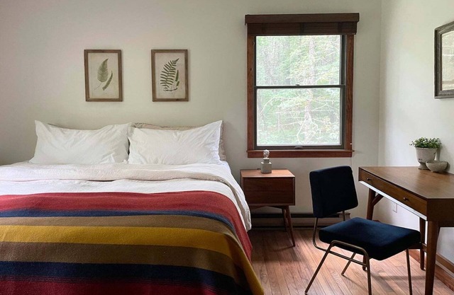 A peaceful, quaint cabin in the woods offers a country-side escape for couples, small families, and friends.