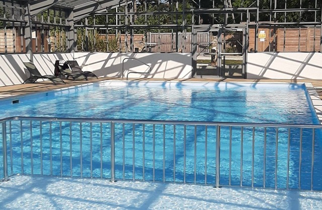 B032 3-bedroom wooden chalet on secure estate with covered swimming pool.