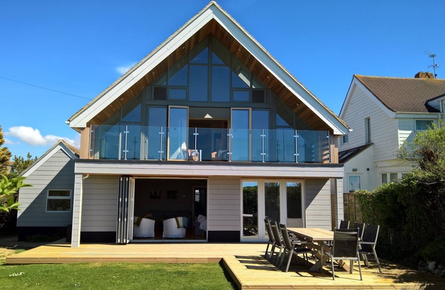 Beach Front Holiday Home on private road with views out to sea. 100+ 5* Reviews