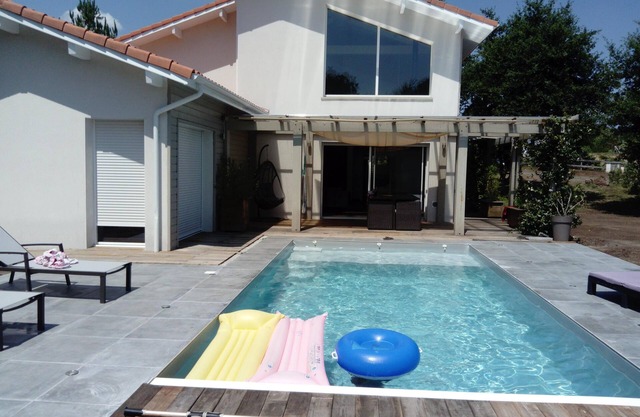 beautiful contemporary house on raised ground with swimming pool and pool house