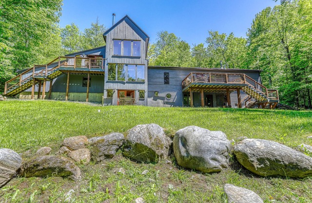 Beautiful, modern home w/ a spacious deck, pool table, & multiple fireplaces