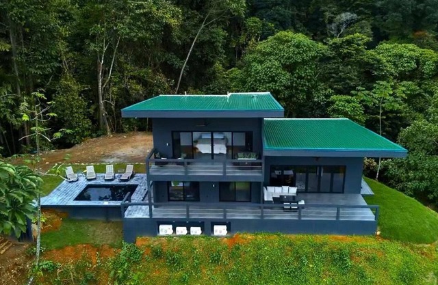 Beautiful new home with wrap around views of the ocean and two waterfalls