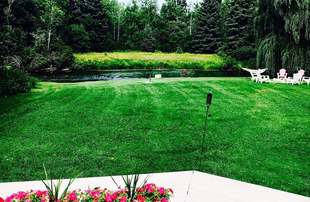 Beautiful private home on the Boardman River with large yard, deck and hot tub.