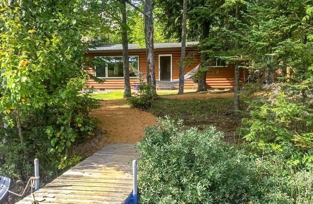 Dog-friendly lakefront cabin w/wood fireplace, patio & firepit - kayaks & canoe!
