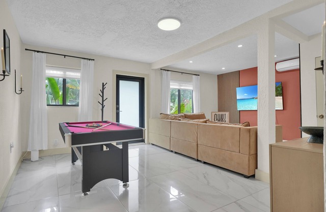 Enchanting 2-bedroom house with a Pool Table, Ping Pong, Patio, Gated Parking