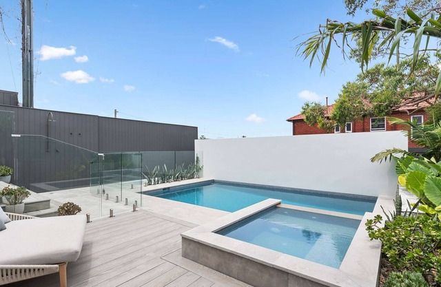 Exceptional renovated 4BR home with pool and views, walk to beach