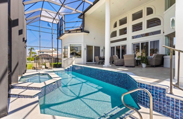 Exquisite waterfront home with lanai, heated pool and spa(hot tub), and internet