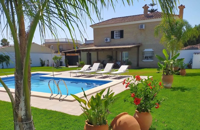 House with tennis court and pool next to the beach