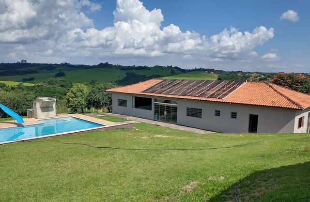 Huge farm with pool, game room and lots of green.