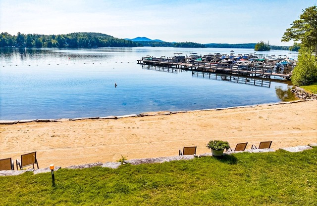 Idyllic lake retreat with beach access, firepit, wraparound porch, & great views