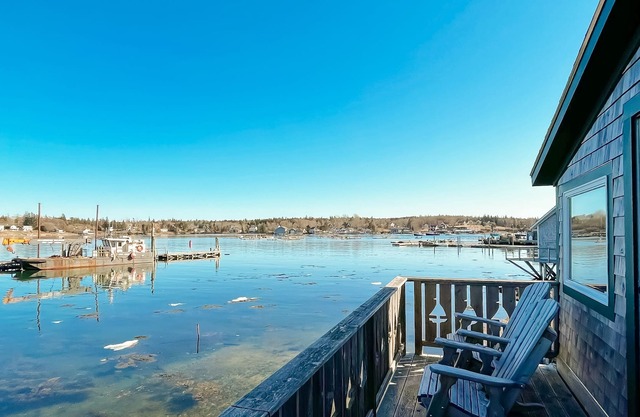Inviting waterfront apartment with balcony, full kitchen, & stunning view