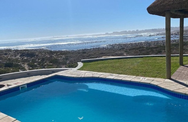 Large villa with warm pool on the beach