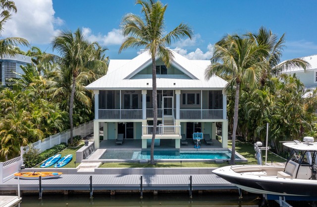 Luxurious tropical water-front Heated pool home with Boat Dock and two master .