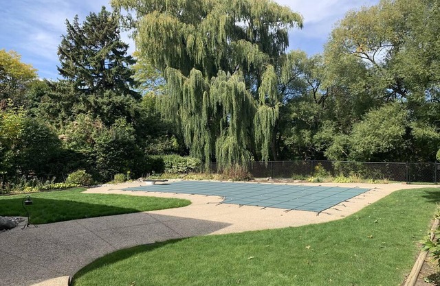 Master bedroom with picturesque view to backyard and ravine