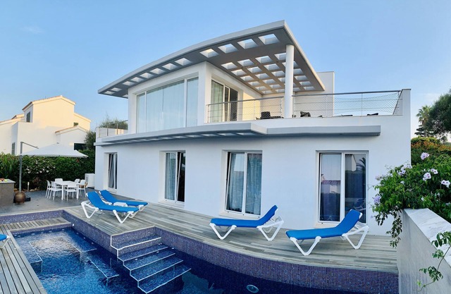 Modern luxury villa with pool and stunning sea views.