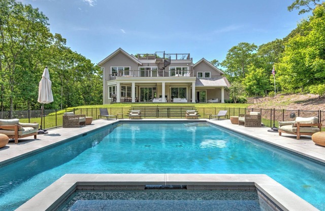 Modern-style home with heated private pool, open-floor plan, ample natural.