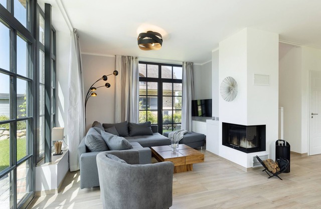 Modern thatched roof house "Haus Strandperle" with fireplace and sauna near the beach