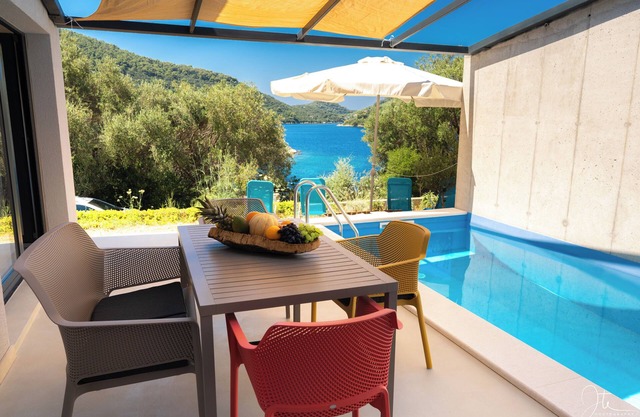 Modern villa in a picturesque bay: quiet location, pool & natural intimacy