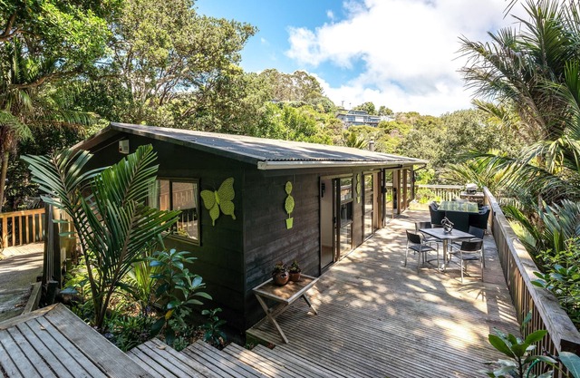 Near Onetangi beach, Treetops is a family bach on the edge of the forest.