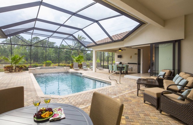 overlooking a nature preserve and lake, this pool with spa home has it all