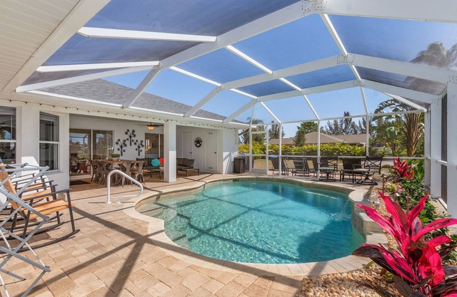 PARADISE COVE- Spacious Canal Home with htd saltwater Pool! Sleeps 13!