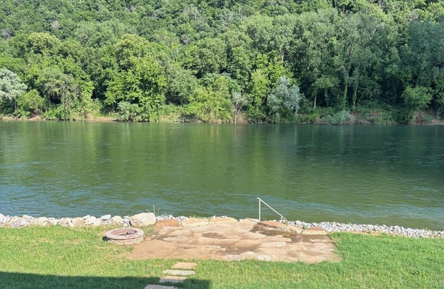 Private riverfront getaway with direct steps to fishing paradise.