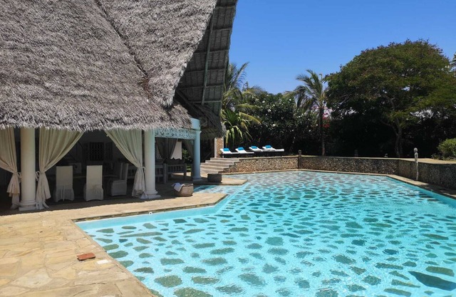 Private villa with swimming pool and tropical garden.