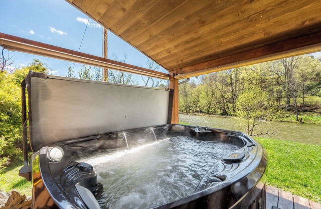 Riverside retreat with hot tub, scenic views, rustic charm & open-plan luxury – perfect escape!