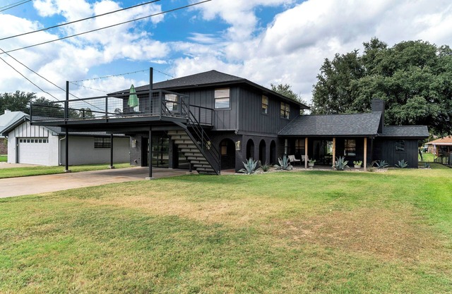 Rockstar waterfront lake house! Mid century modern with large 2 story party deck