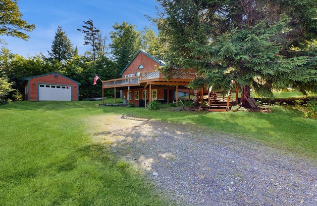 Scenic retreat with a spacious deck, gas fireplace, and Moosehead Lake views