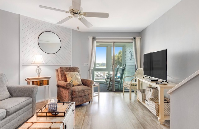 Second-floor villa w/river views & community pool, tennis courts, and dock