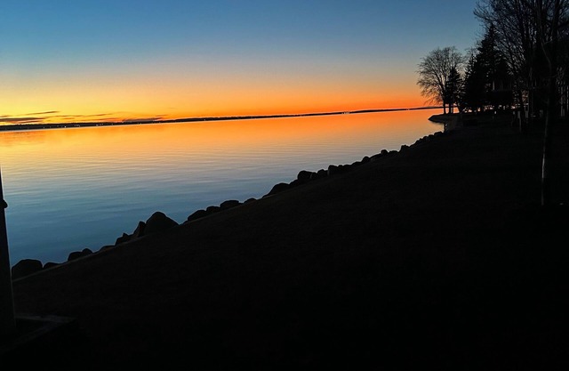 Spacious 4-bedroom lakefront house on Houghton Lake with beach and tiki bar