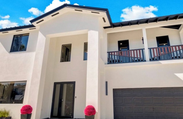 This Miami Vice Villa home is a stunning Saltwater Heated pool/Jacuzzi spa Oasis