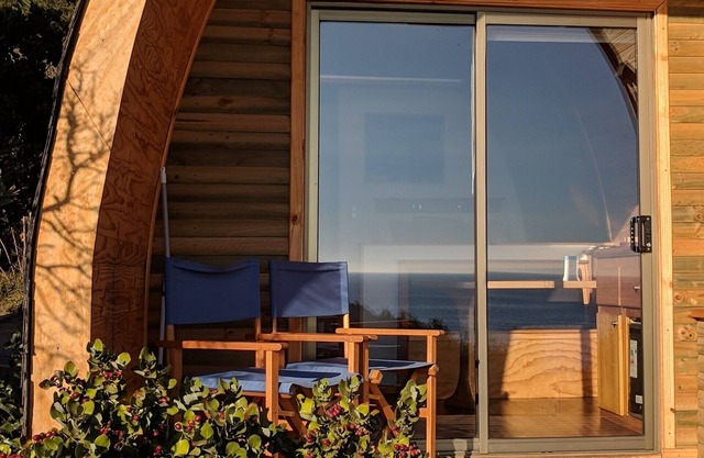 Tiny cabin, sailboat inspired design. Sorrounded by forest by the beach