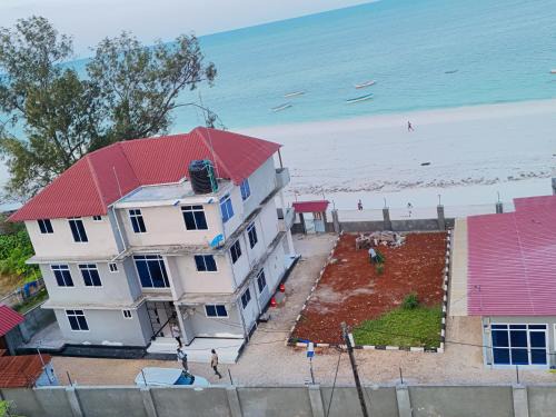 Uroa Escape Zanzibar - Beachfront 2BR Condo with Terrace, AC & WiFi