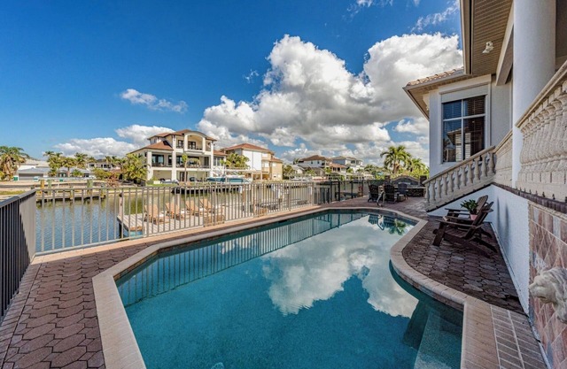 Waterfront Retreat! Breathtaking Water Views - Sparkling Pool & Dock - Walk to the Beach!