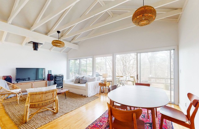 Woodsy island home with large deck, open layout, WiFi, kitchen & ideal location