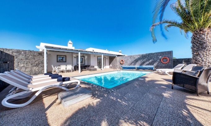 Playa Blanca Ski Chalet | Blue Waves House - Heated Pool, BBQ and Bicycles By Lanzarote Vacation Homes