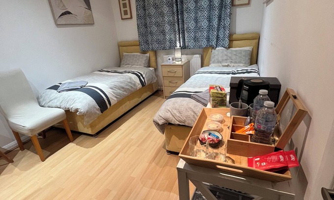 Kettering House | Comfortable Twin Bedroom with shared shower room at The Bungalow in Kettering.