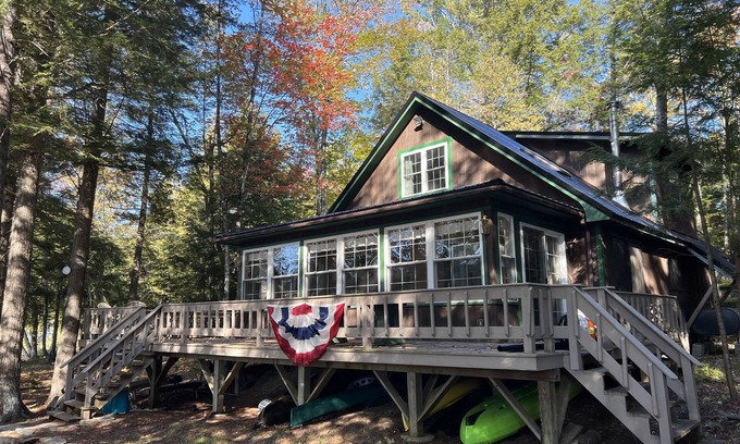 Bowerbank Cottage | Cozy Sebec Lake front cabin with dock and fire pit