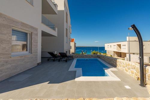Kolan Apartment | Dolphin view with a pool by the beach