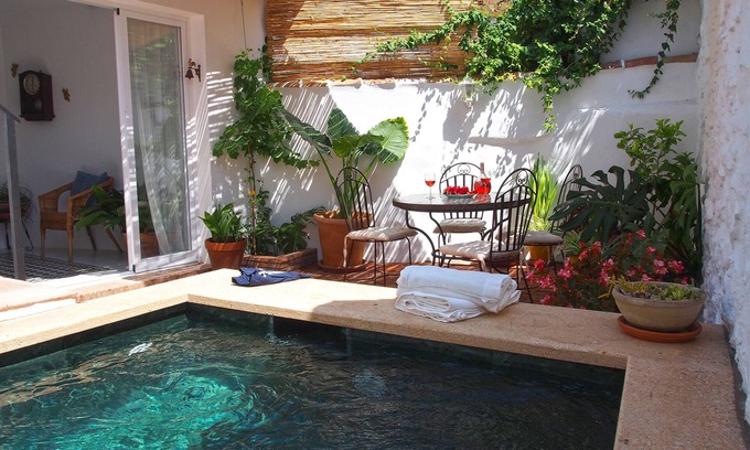 Riogordo House | El Patio de Lola, an Andalusian village house with green marble splash pool.