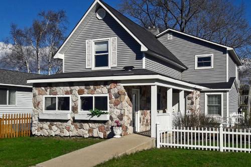 Beulah House | Elegant Stone Cottage Steps to Crystal Lake Beach