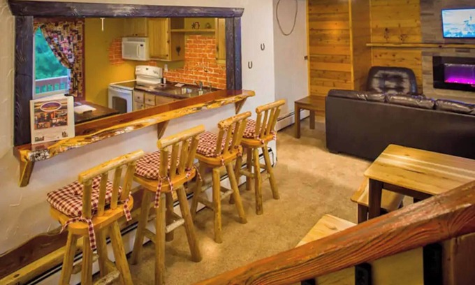 Rice Lake Ski Chalet | Enjoy a quiet stay on your own private deck by the lake in Room 21: Ponderosa-a Western Themed Chalet