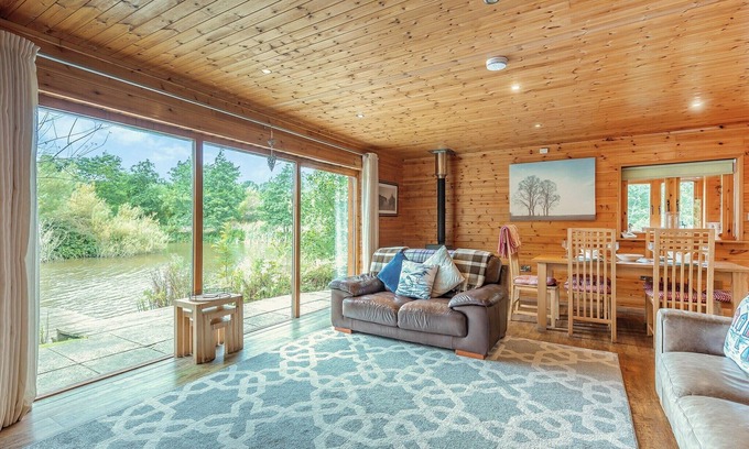 Menai Bridge Ski Chalet | Ground floor: Spacious open plan lounge, kitchen, dining area with log burner.